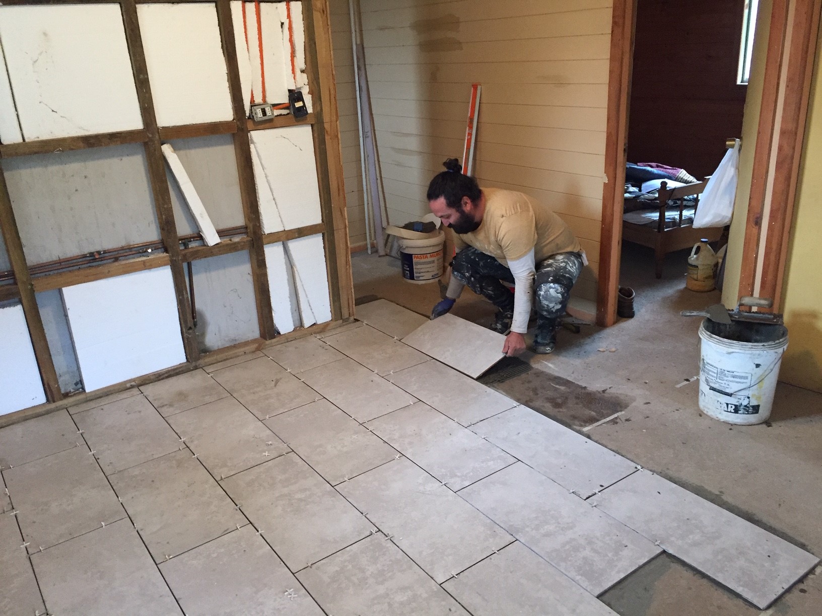 Cesar laying floor tiles